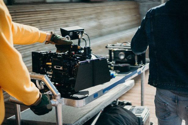 Equipamentos profissionais de filmagem em um set de cinema, com integrantes da equipe se preparando para gravar