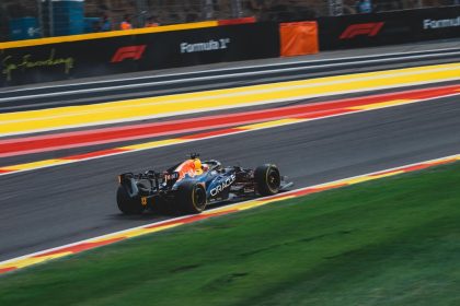 Carro de Fórmula 1 em alta velocidade no circuito de Spa-Francorchamps, na Bélgica, durante um dia ensolarado de corrida.